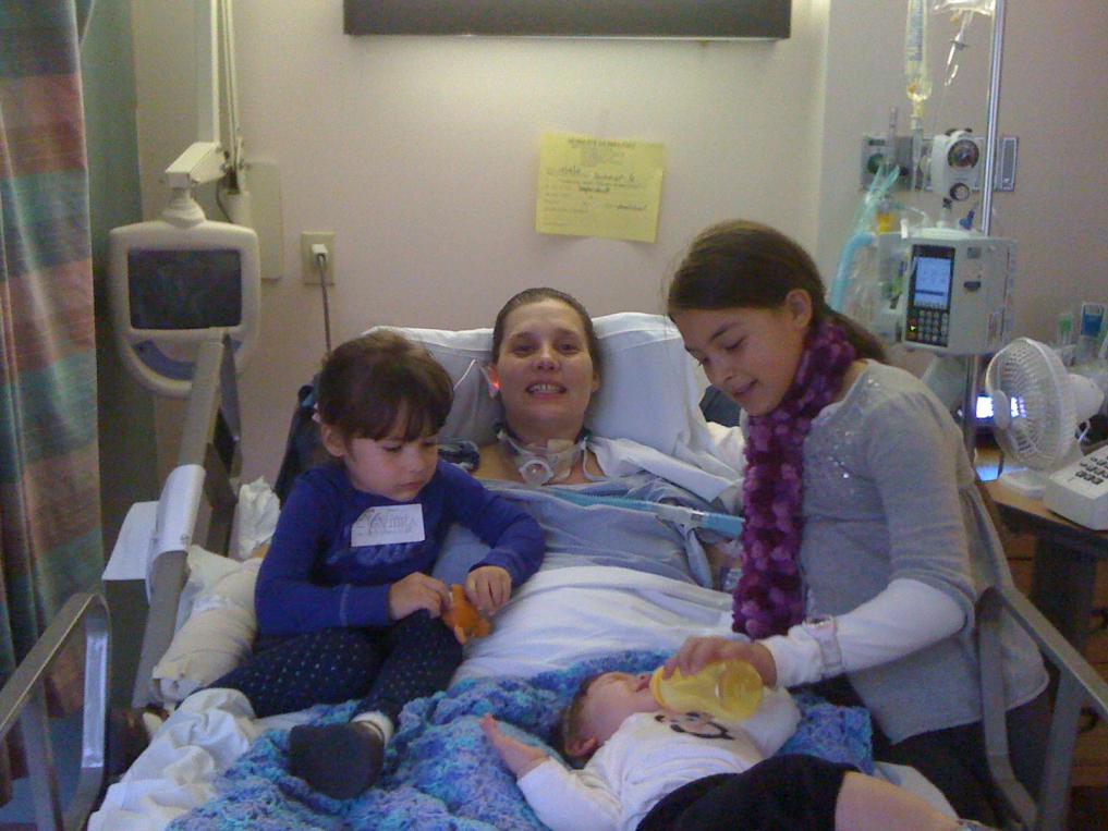 My daughter with 3 grand kids in hospital with first afghan I made.-181-jpg